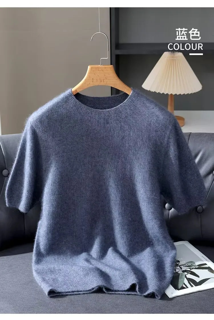 Blue sweater on a hanger with 'COLOUR' text against a neutral background