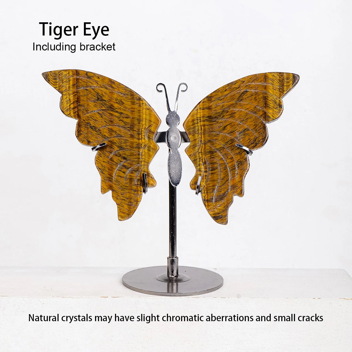 Butterfly-shaped tiger eye crystal on a stand with text about natural crystals.