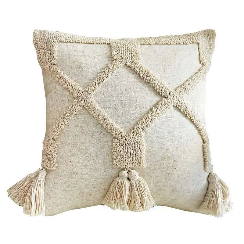 Decorative pillow with textured pattern and tassels on a white background