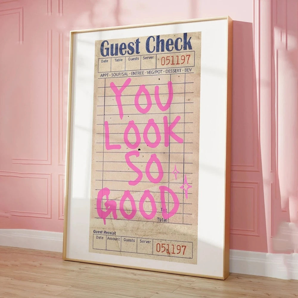 Framed vintage-style check with 'You Look So Good' text on a pink wall.