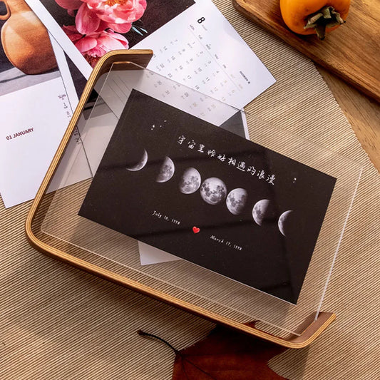 acrylic wooden photo frame displaying moon print on curved wooden base