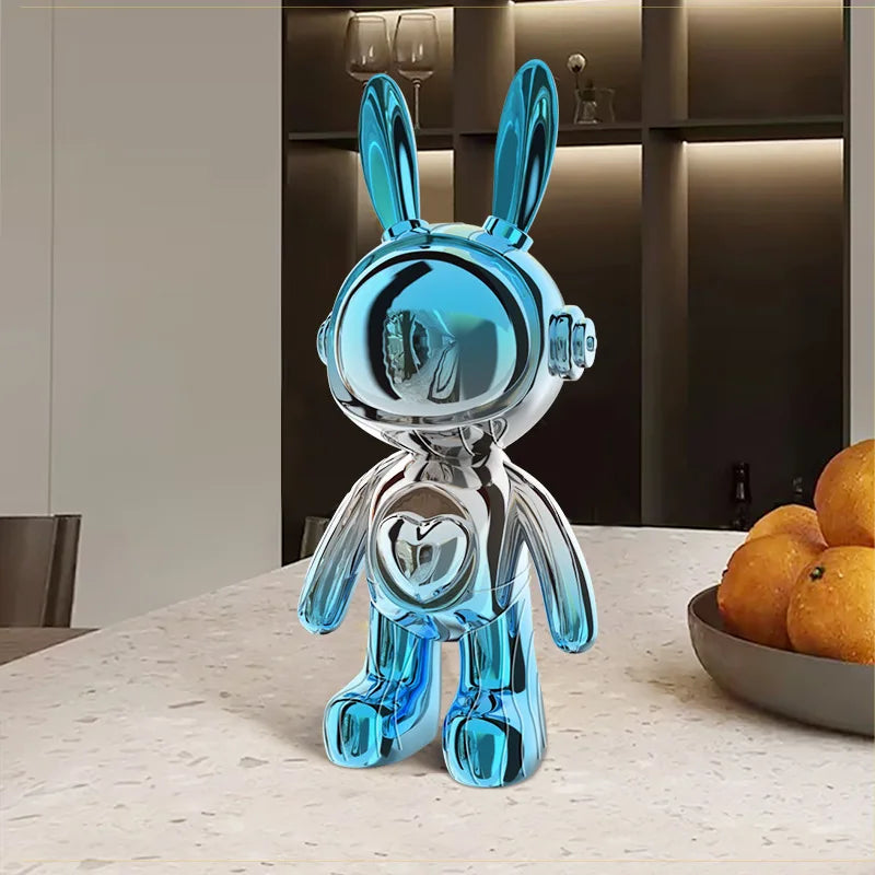 Blue glass rabbit sculpture on a table with a neutral background
