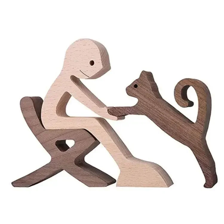 Wooden figurines of a person and a cat on a white background