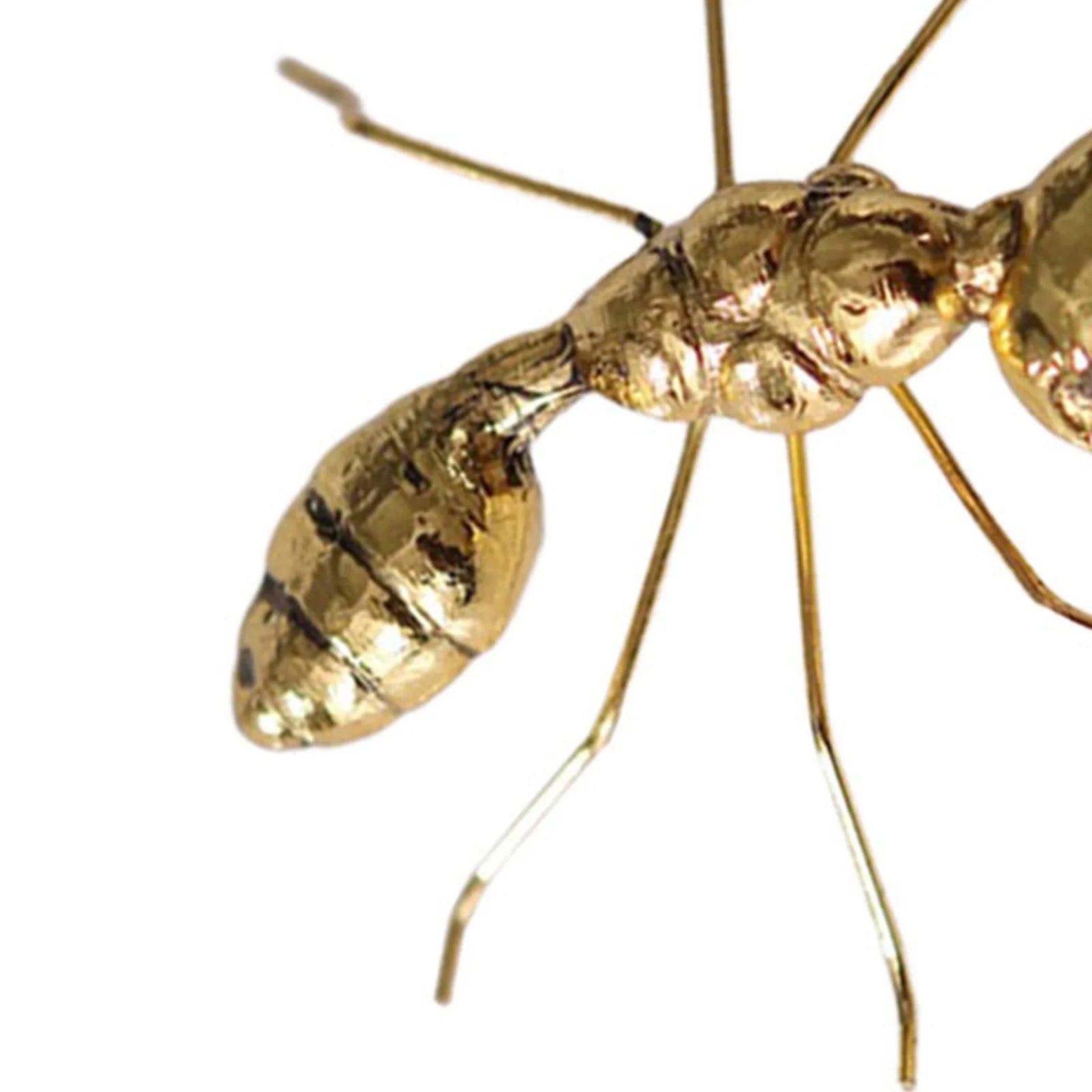 Gold ant figurine on a white background