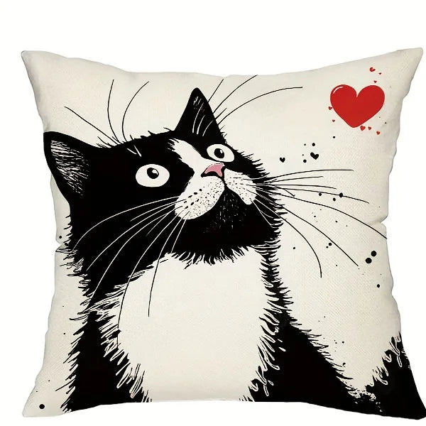 Pillow with a black and white cat illustration and a red heart on a beige background