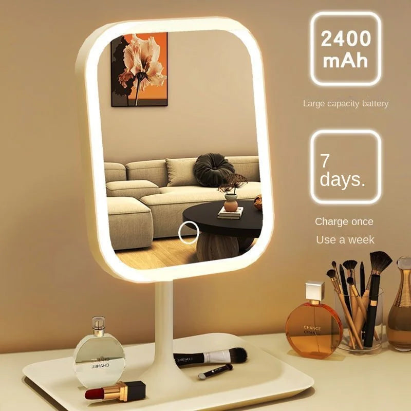 Lighted makeup mirror with cosmetic items on a table, battery capacity information displayed.