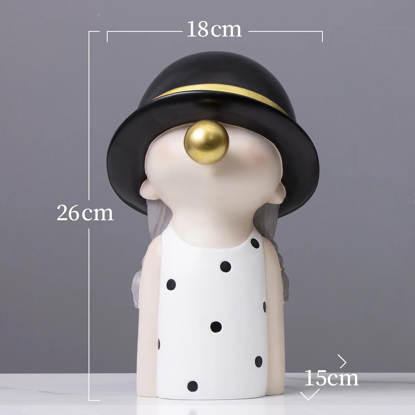Decorative figure with a black hat and gold ball on a gray background
