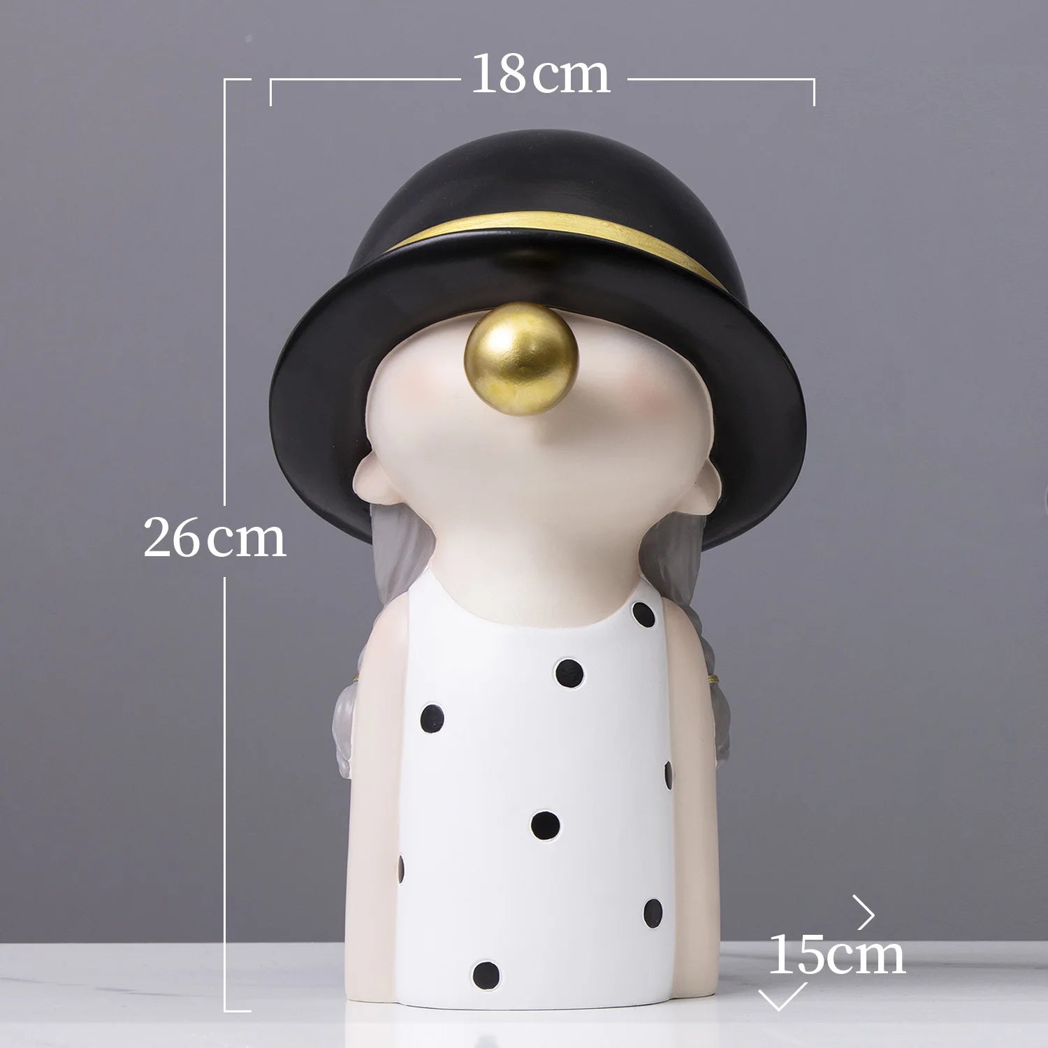 Decorative figure with a black hat and gold ball on a gray background