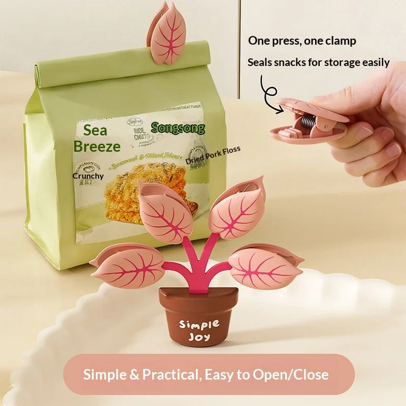 Pink leaf-shaped snack clip used to seal a green snack bag with visible branding.