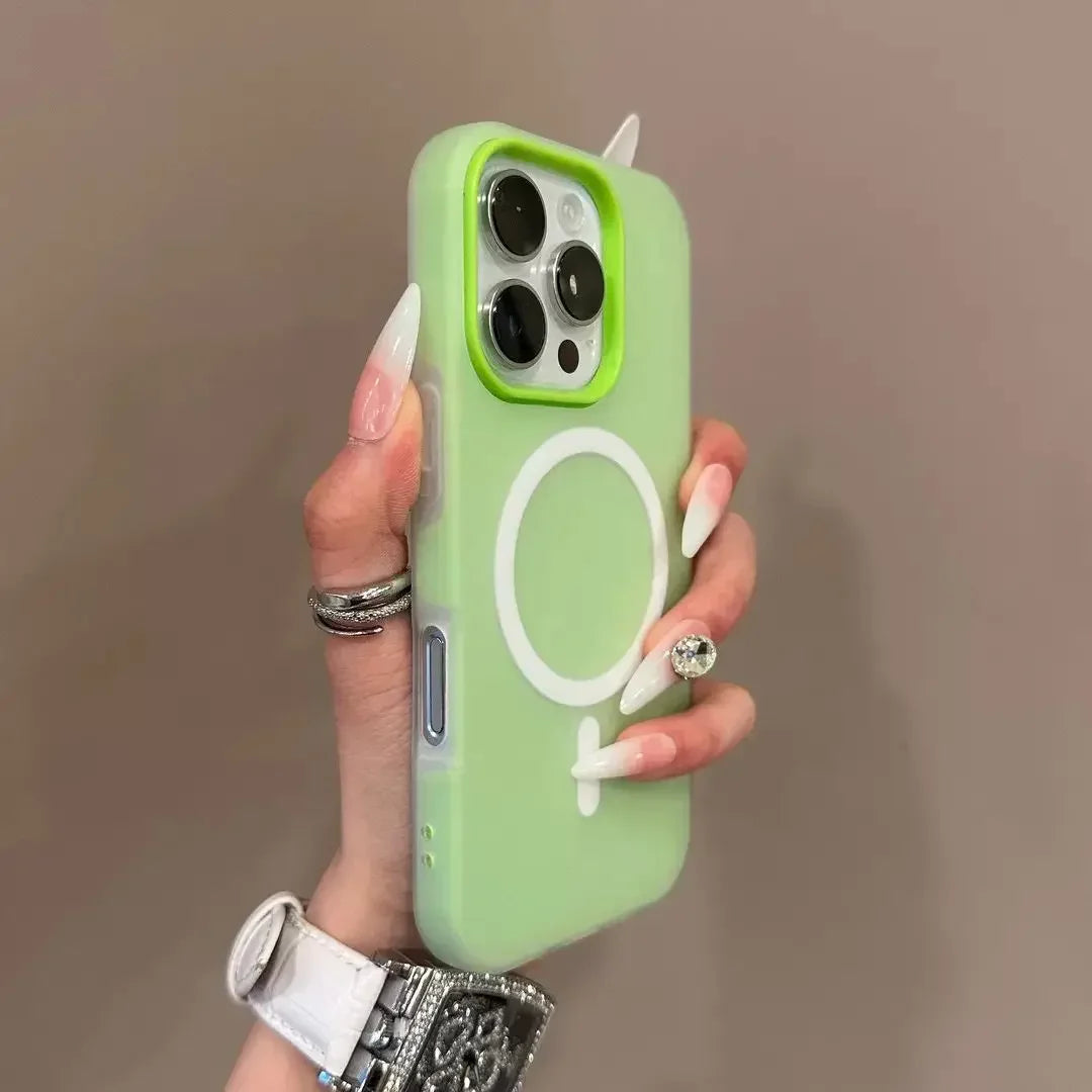 Hand holding a green phone case with a white logo against a brown background