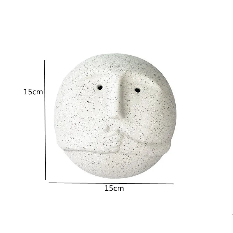 White stone-like face sculpture with measurements on a white background