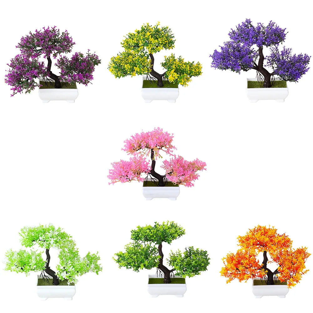 Set of six artificial bonsai trees in pots with different colored foliage on a white background