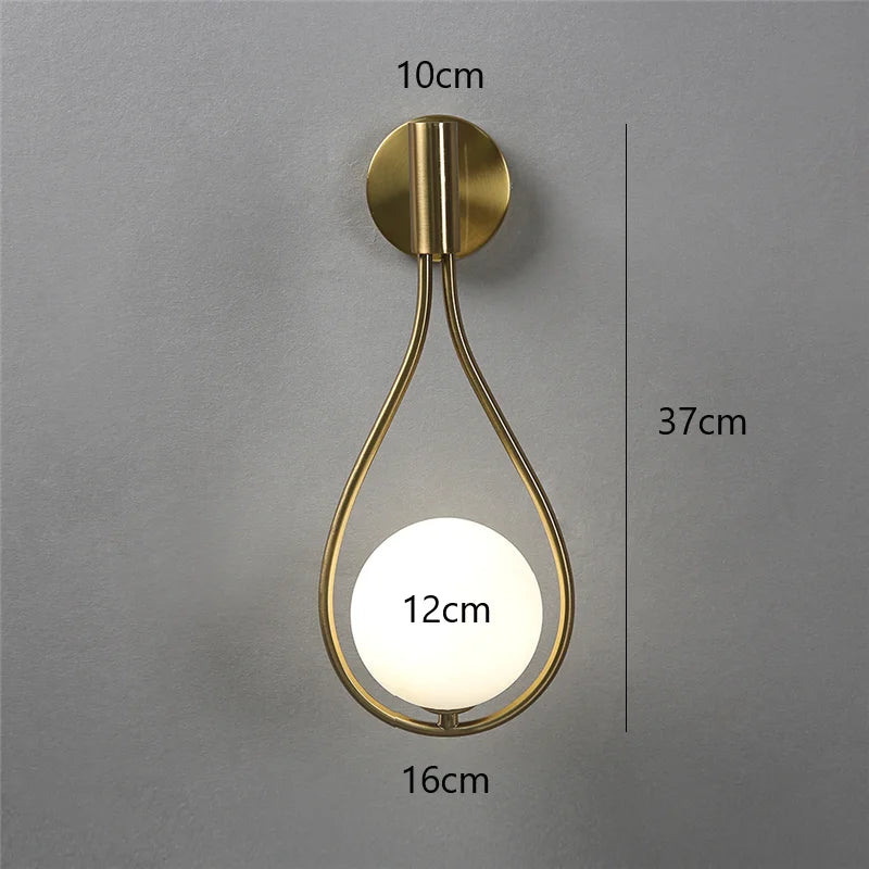 Wall-mounted gold light fixture with measurements on a gray background