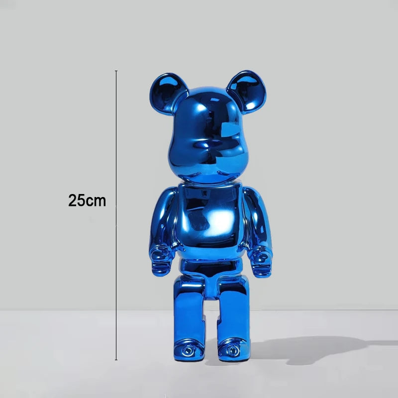 A shiny metallic blue bear-shaped collectible figure standing on a white surface against a light gray background, with a vertical measurement marker labeled 25cm to the left.