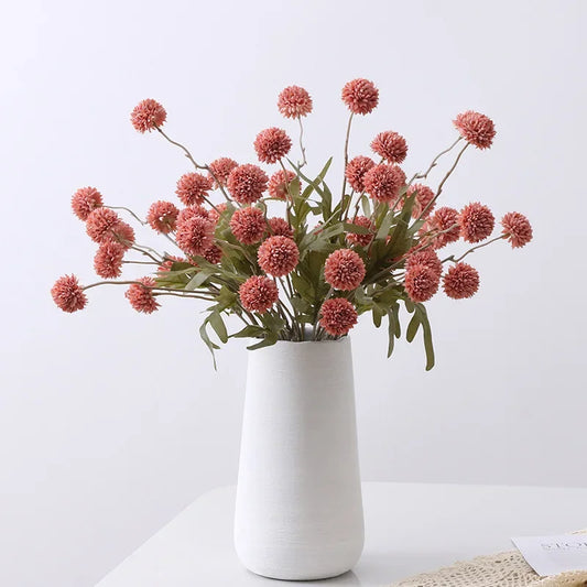 White vase with pink flowers on a white background