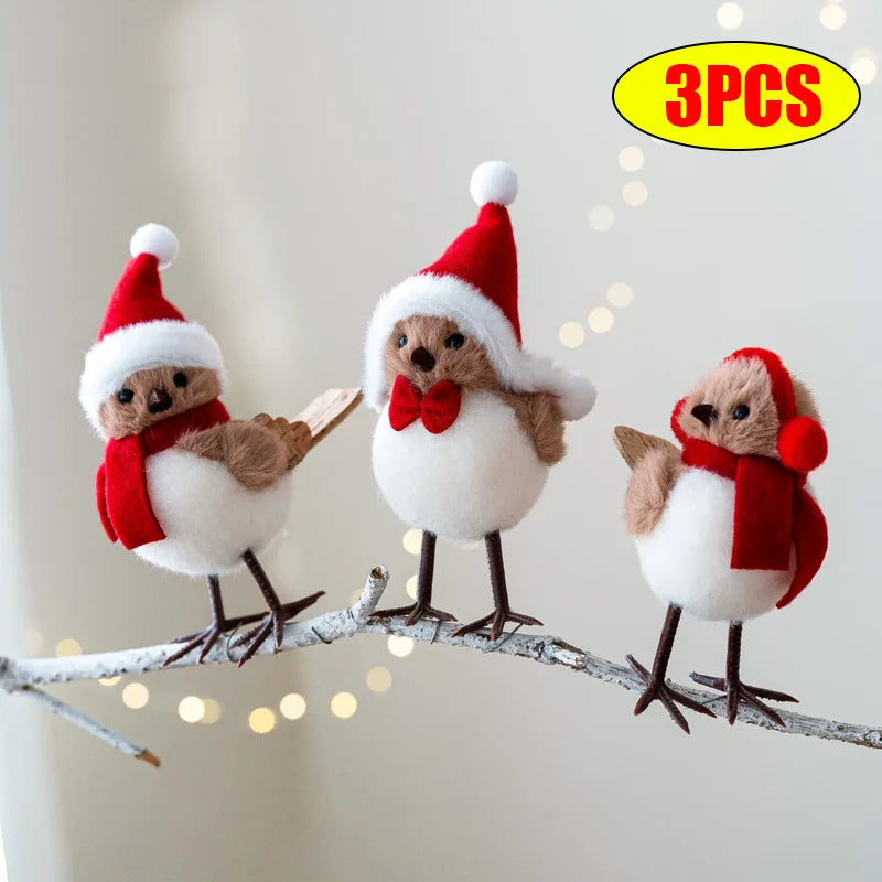 Three festive bird figurines wearing Santa hats and scarves on a branch with a blurred light background.