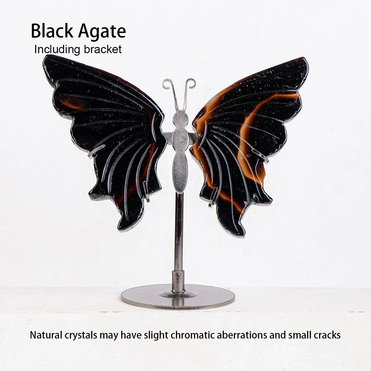 Black agate butterfly sculpture on a stand with text about natural crystals.