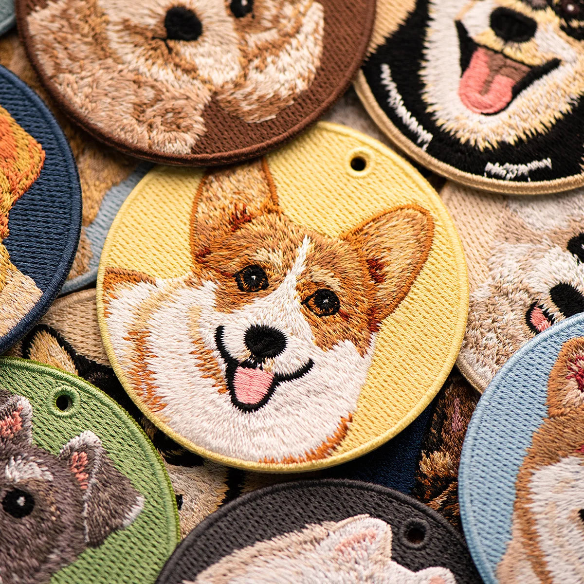 Collection of embroidered patches with dog designs on a colorful background