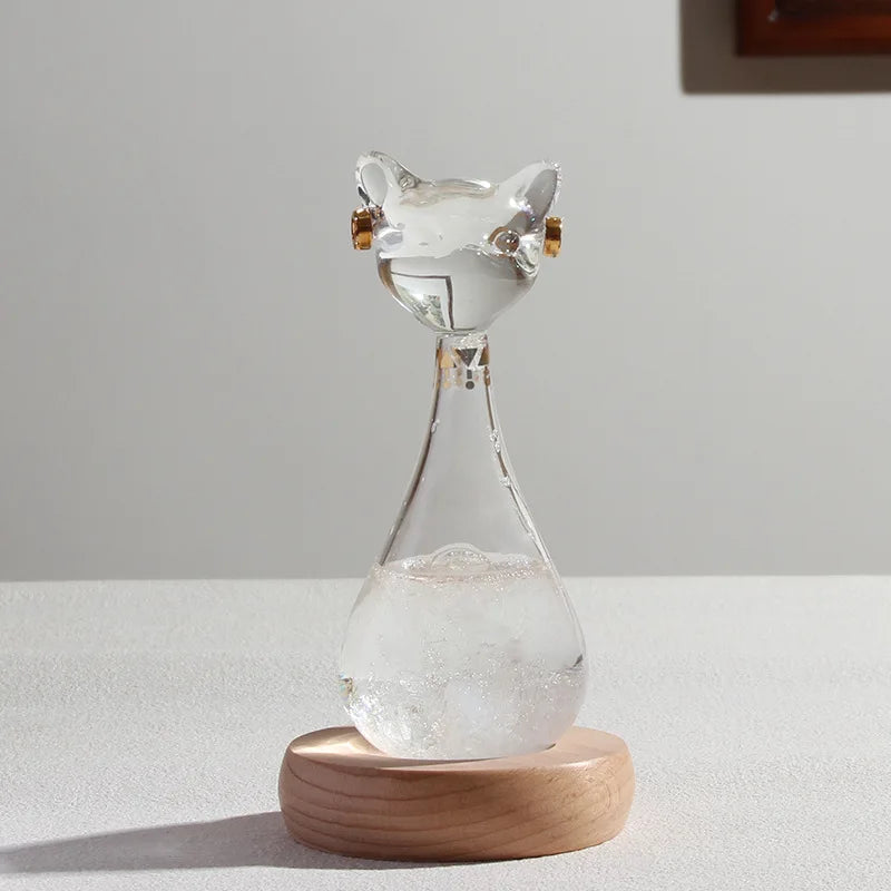 Glass hourglass with wooden base on a white surface