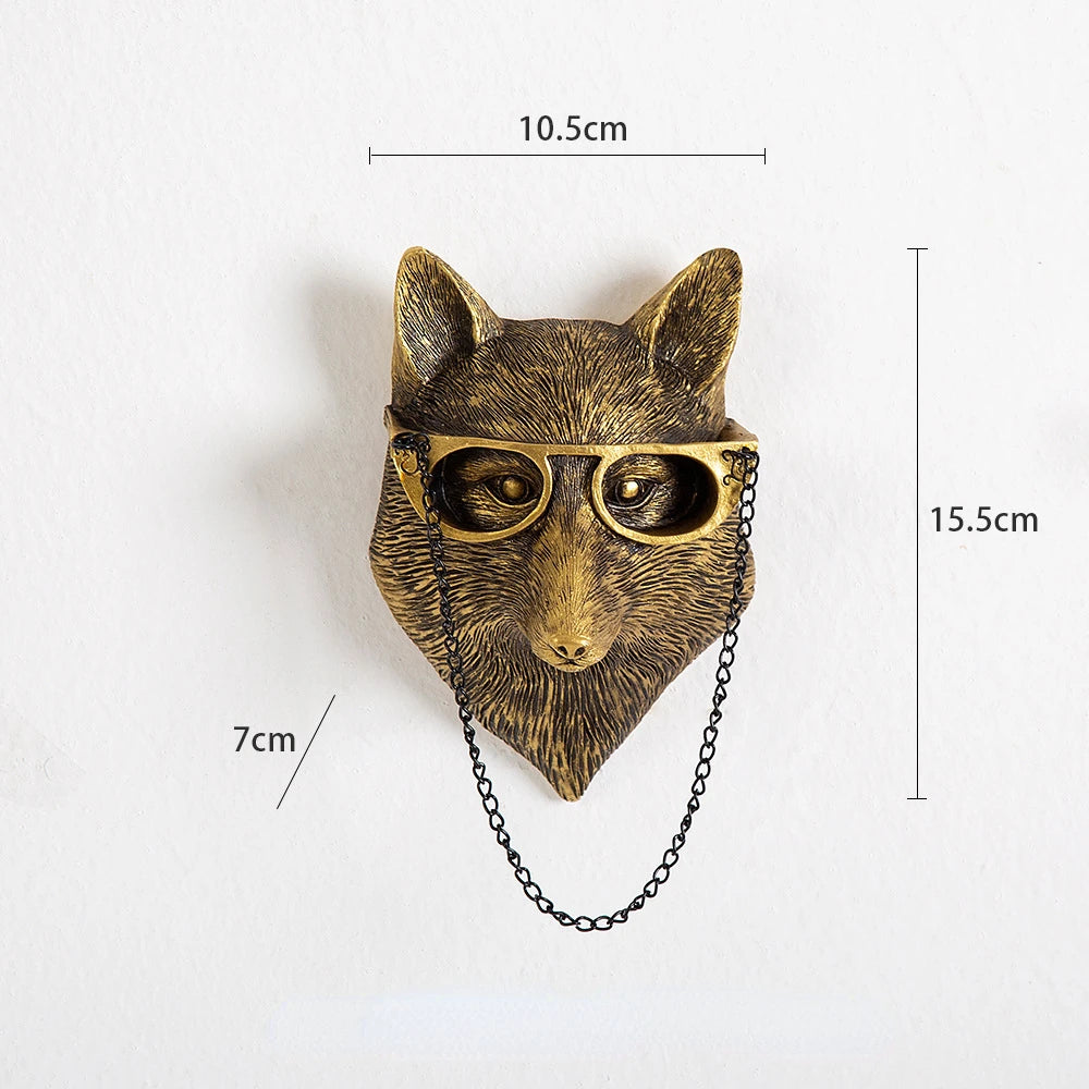 Bronze wolf head wall decoration with glasses and chain, shown with measurements on a white background.