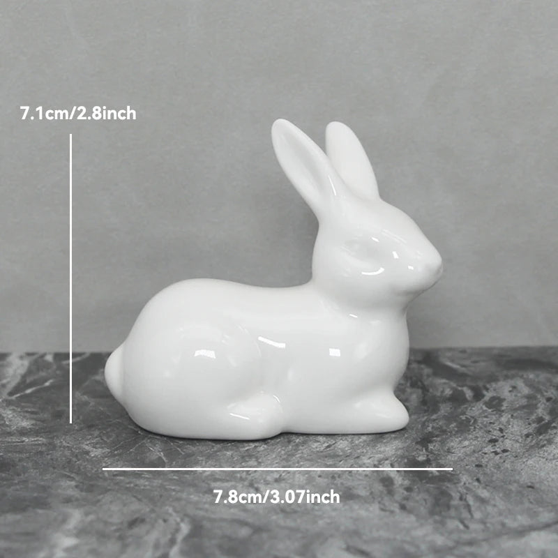 White ceramic rabbit figurine with measurements on a gray surface