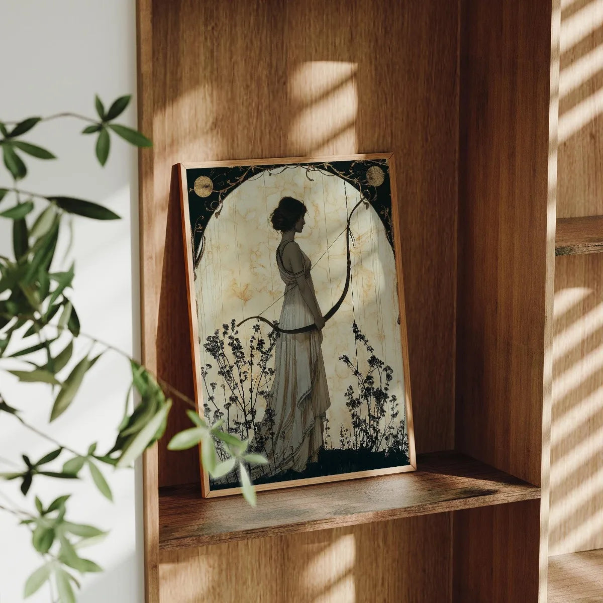 Framed artwork of a silhouette on a wooden shelf with plants and sunlight.