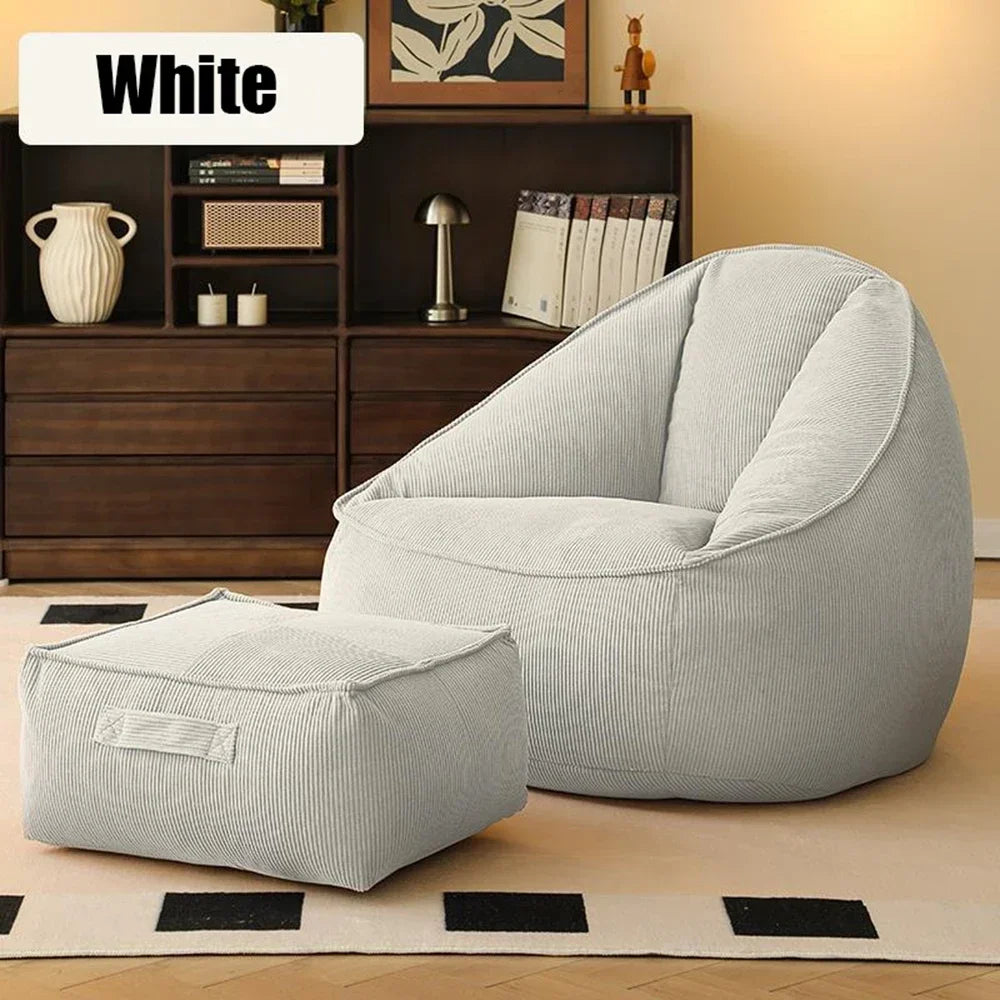 Gray bean bag chair and ottoman in a room with wooden furniture and decor.