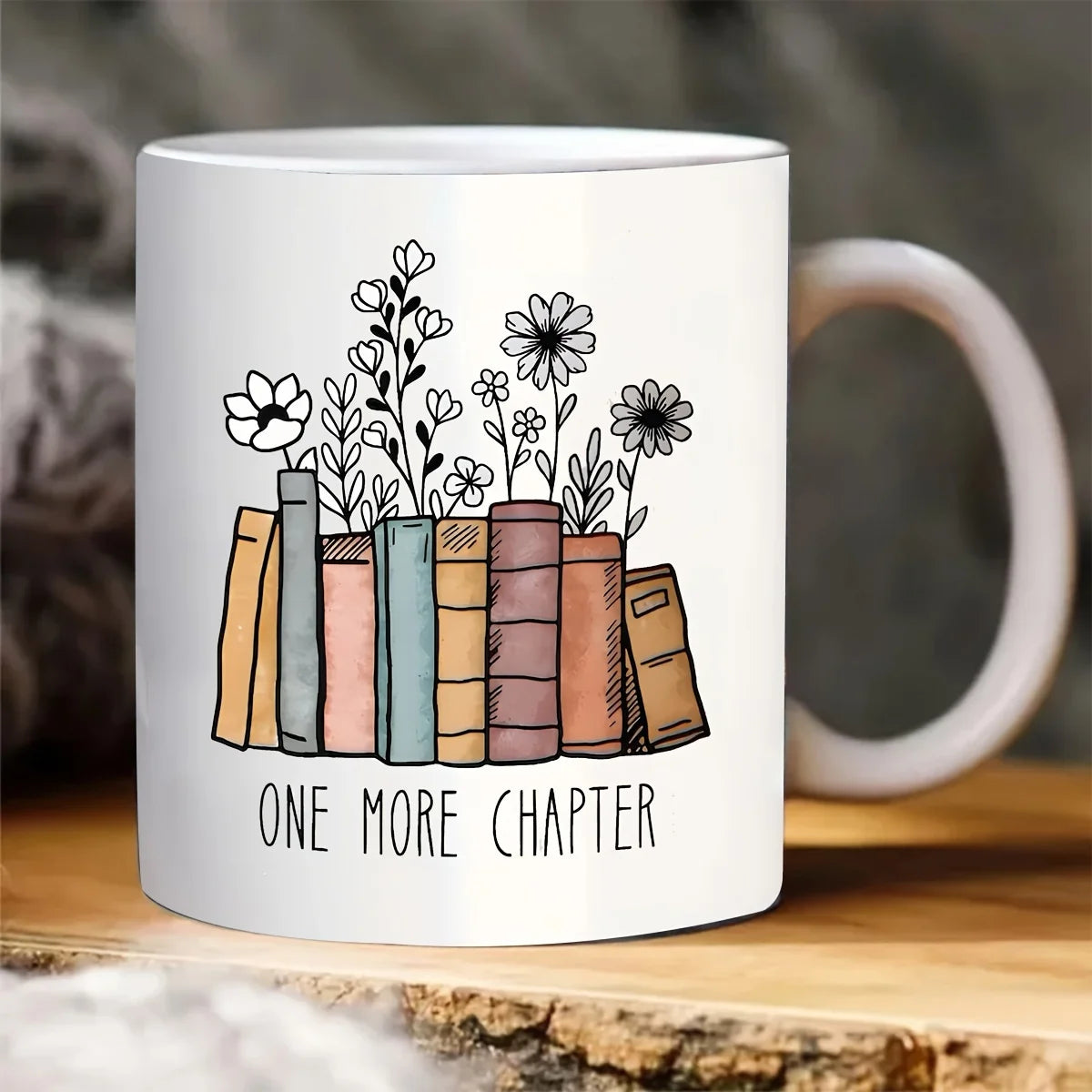 Floral ceramic mug featuring the phrase "Another Chapter" alongside an illustrated book design. A charming 320ml coffee cup for book lovers, readers and cosy reading nook decor