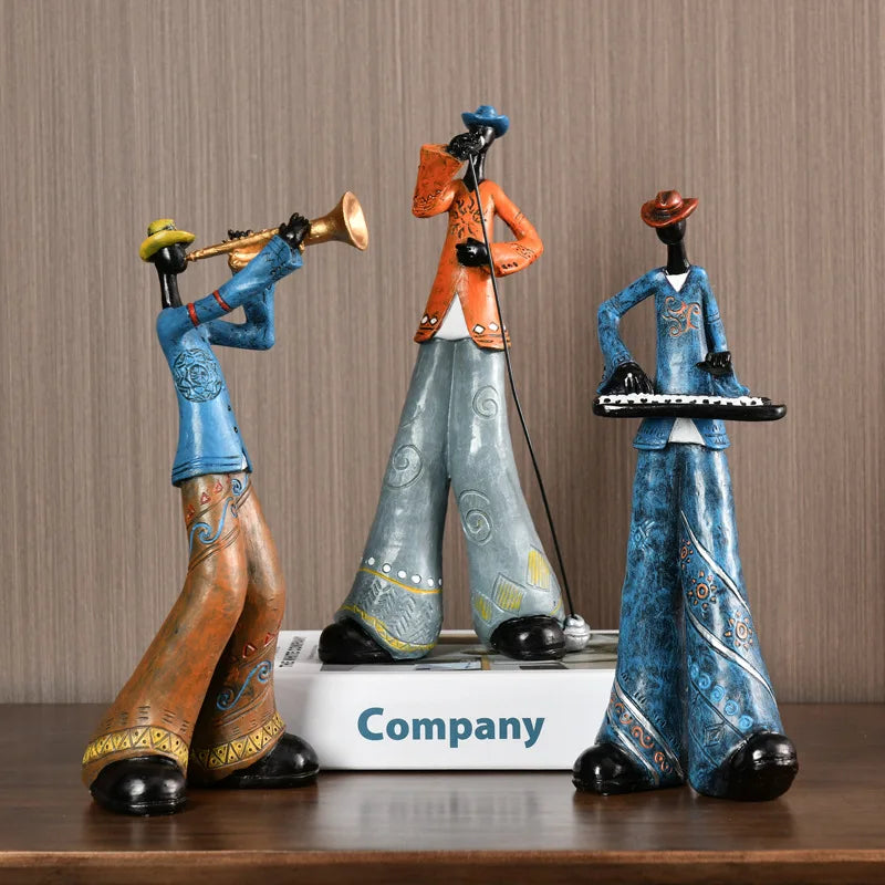 Three colorful figurines on a wooden surface with a neutral background