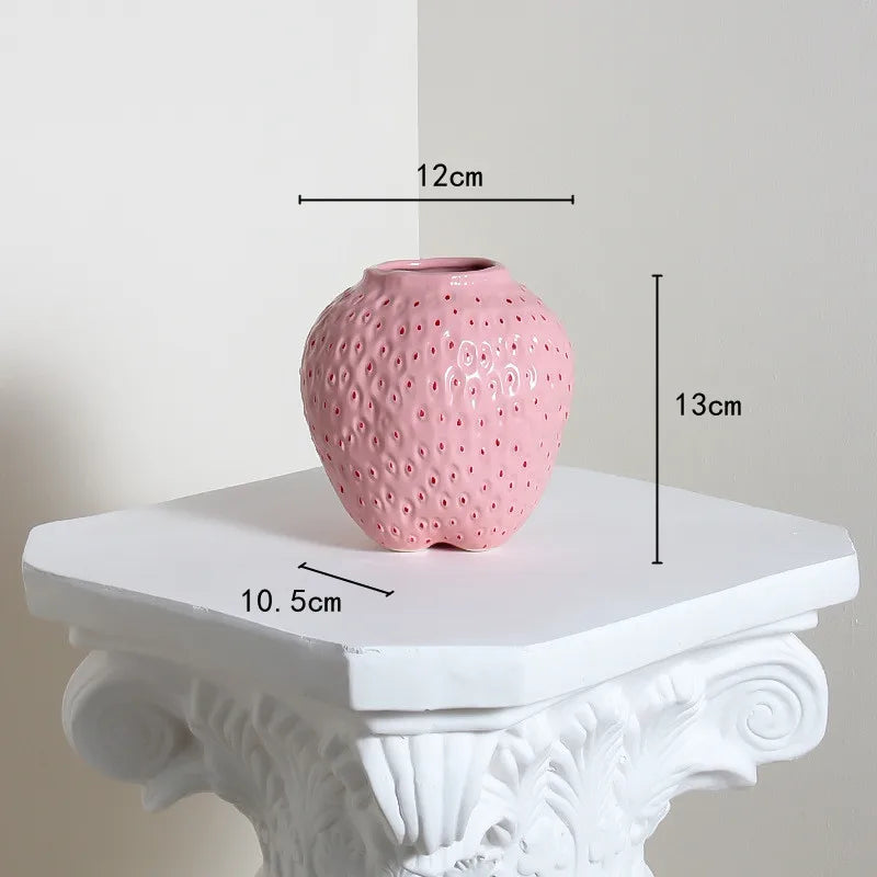 Pink textured vase on a white pedestal with measurements indicated