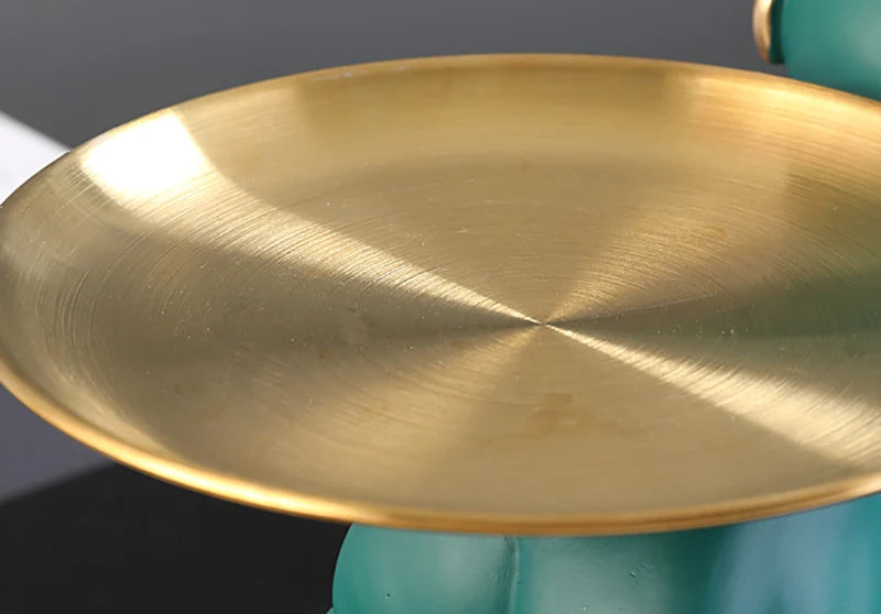Gold plate held by a hand against a dark background