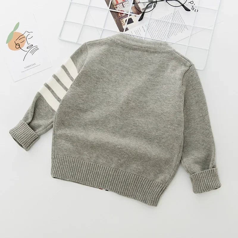 Gray sweater with white stripes on sleeves on a light background