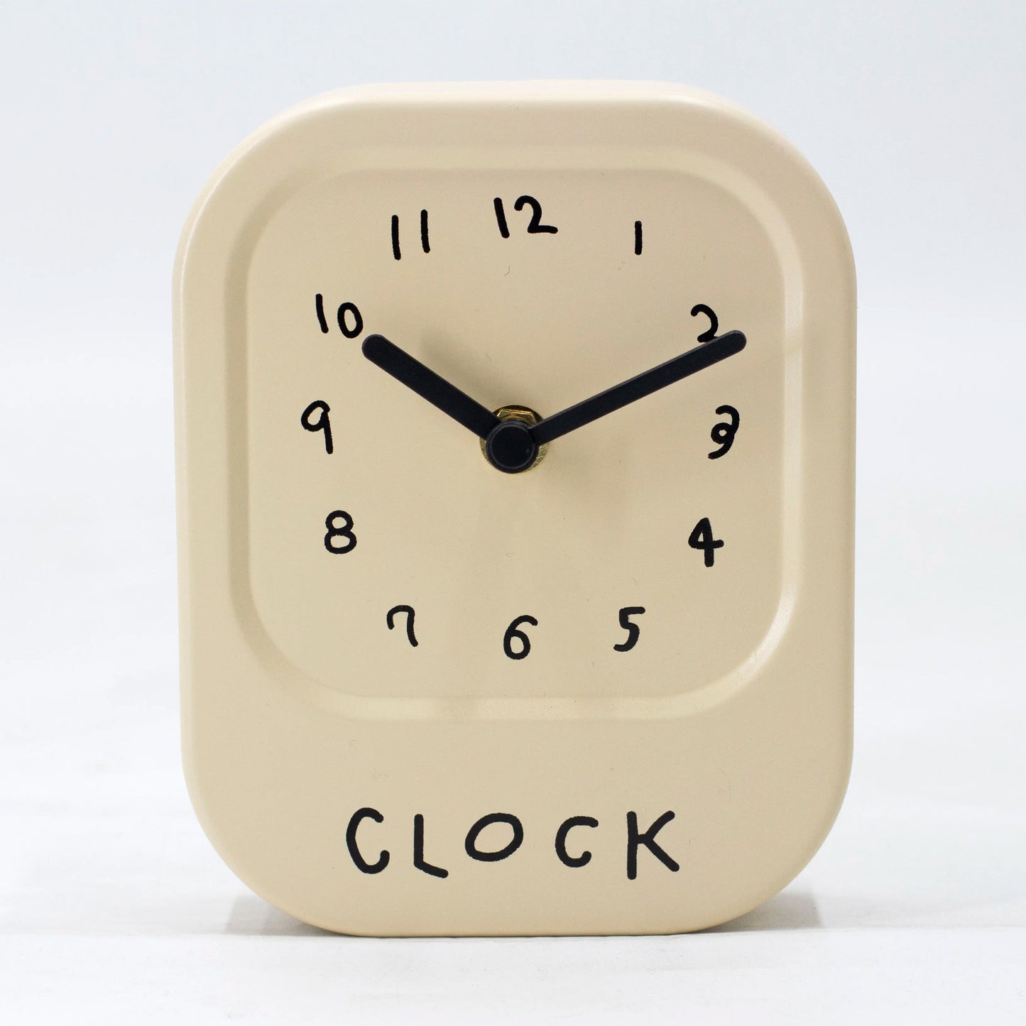 Beige clock with black hands and numbers on a white background