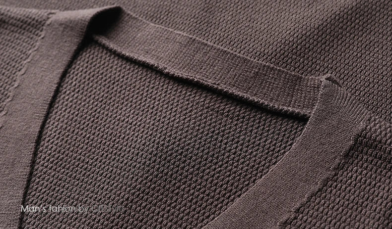 Close-up of a brown textured fabric with a brand logo in the corner.