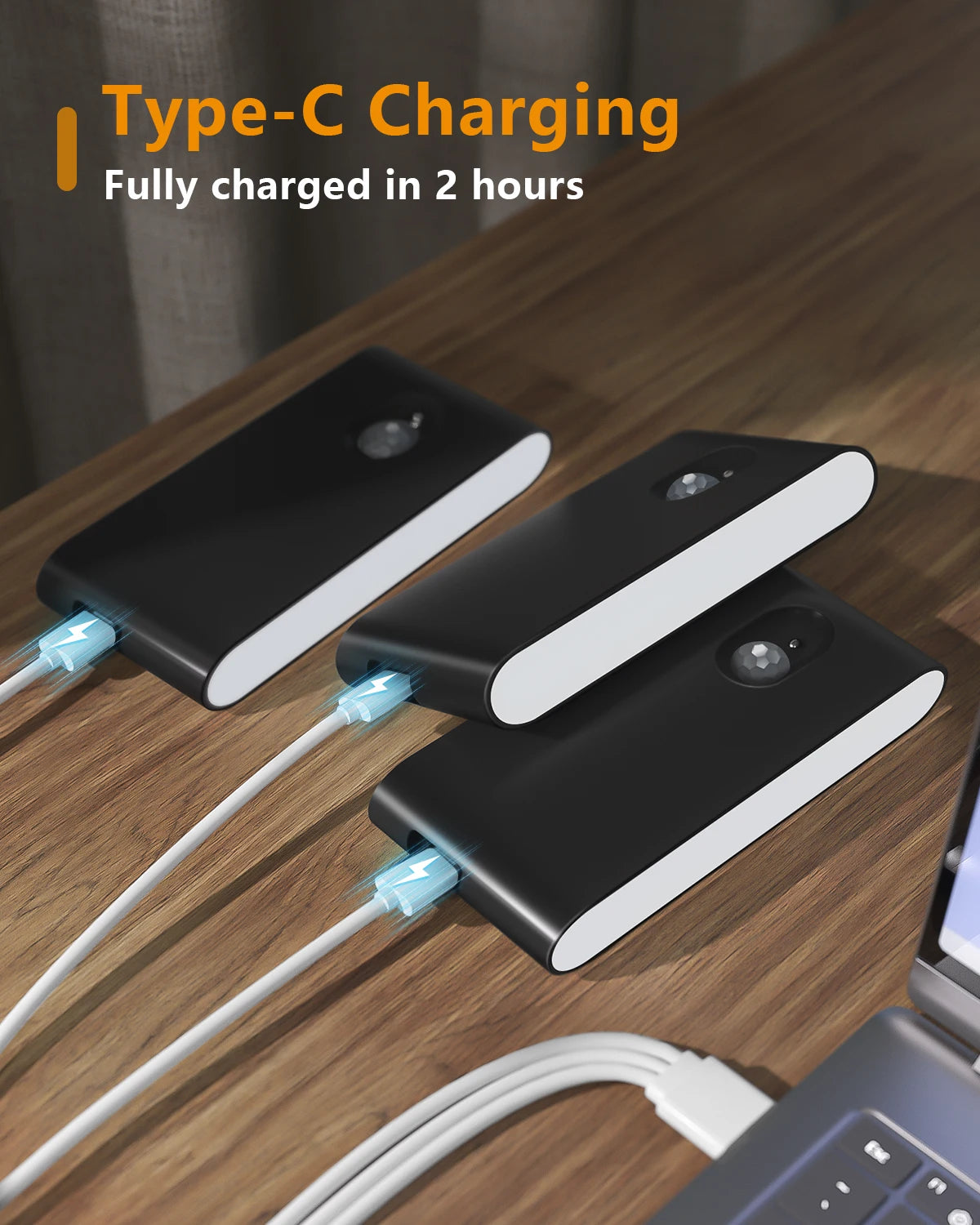 Three black charging blocks with Type-C cables on a wooden surface, indicating fast charging capability.