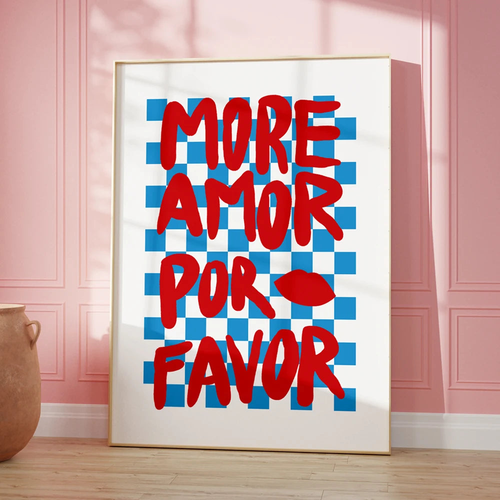 Framed artwork with 'More Amor Por Favor' text on a checkered background in a room.