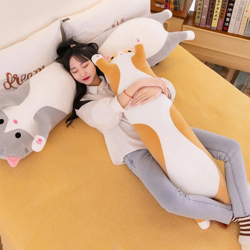 Person lying on a yellow floor with a large cat-shaped pillow