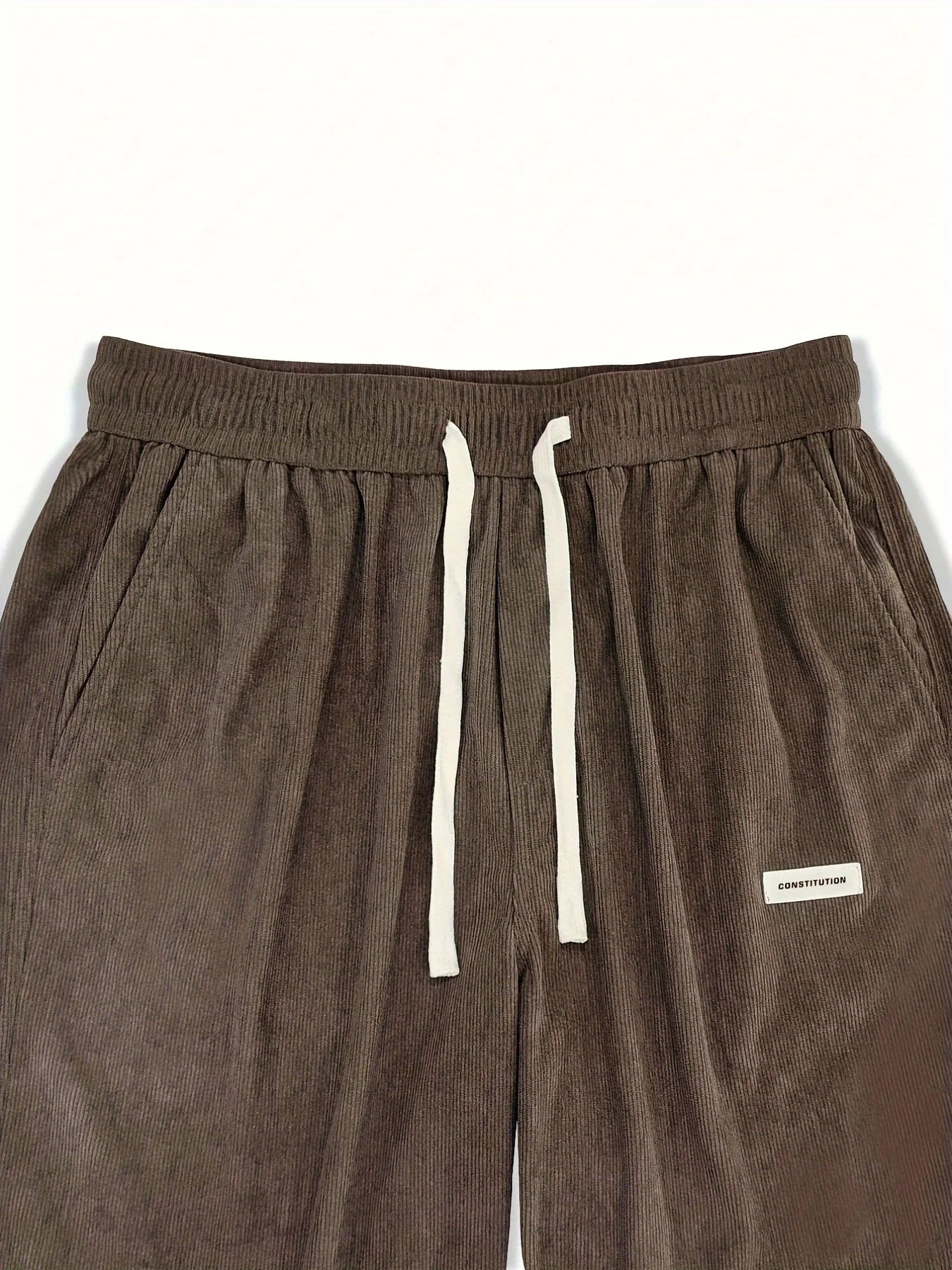 Brown sweatpants with a white drawstring and label on a white background