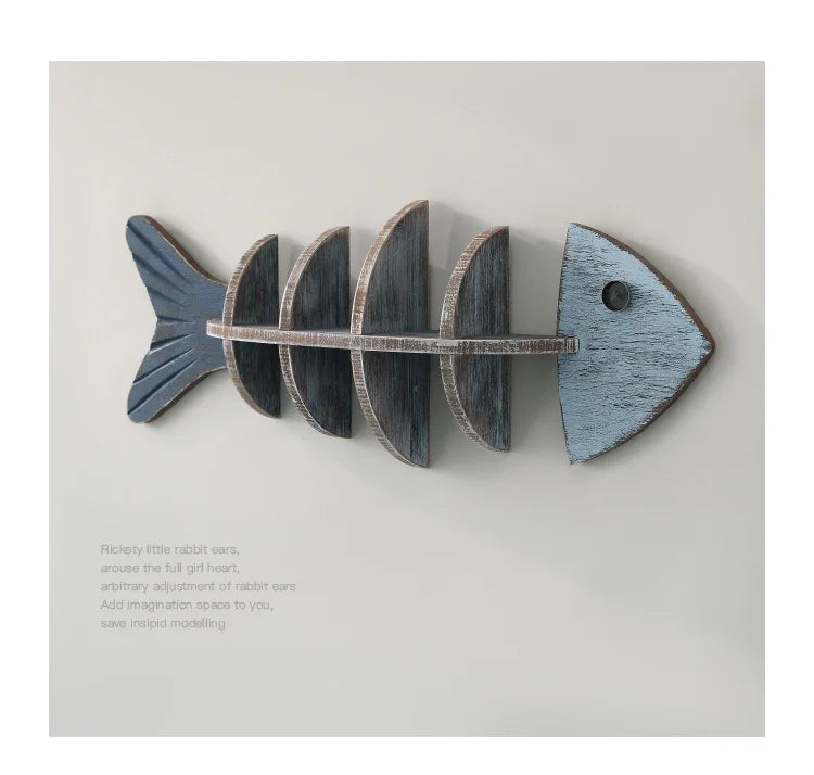 Wooden fish skeleton wall decor on a light gray background