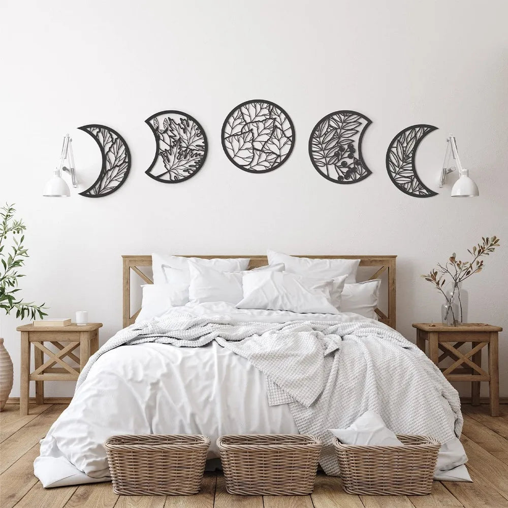 Bedroom with decorative wall art of moon phases above a bed.
