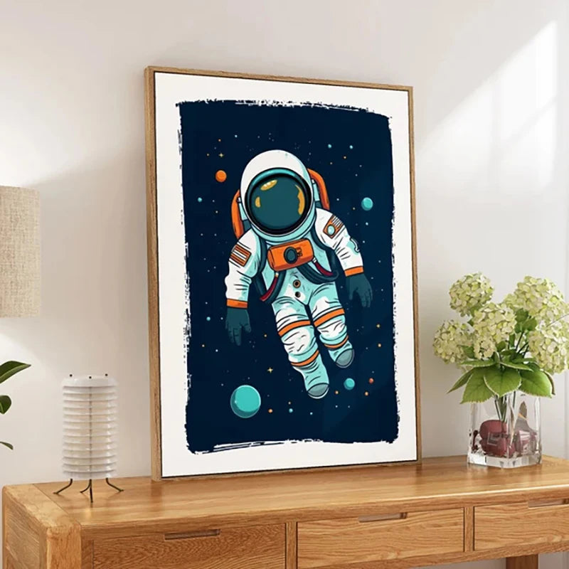 Framed artwork of an astronaut in space on a wooden surface with a lamp and flowers in the background.