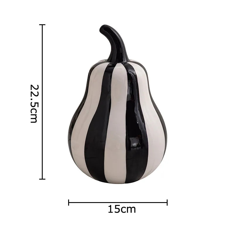 Black and white striped pear decorative object with measurements on a white background
