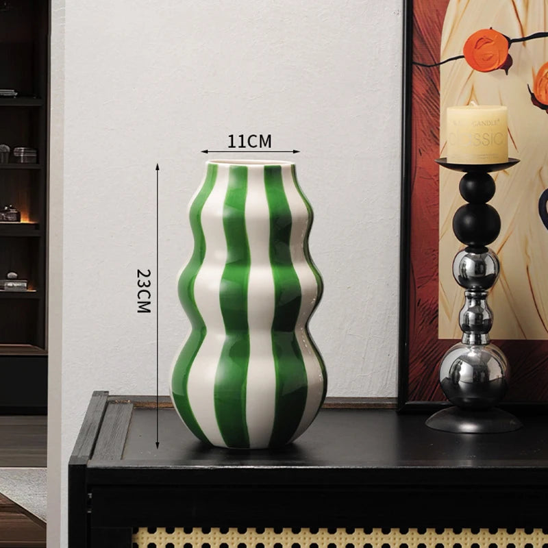 Green and white striped vase on a table with measurements indicated