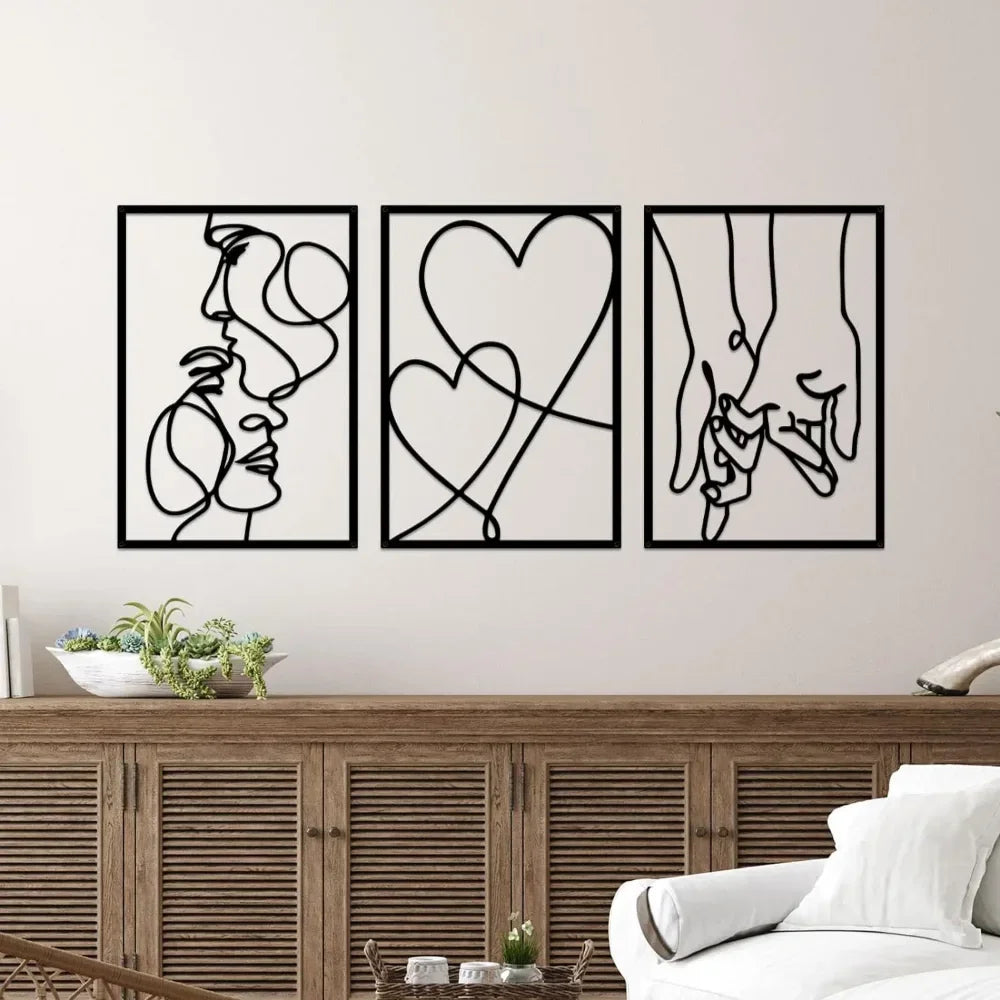 Set of three minimalist black metal wall art designs featuring an abstract couple, intertwined hearts and holding hands in continuous line art.