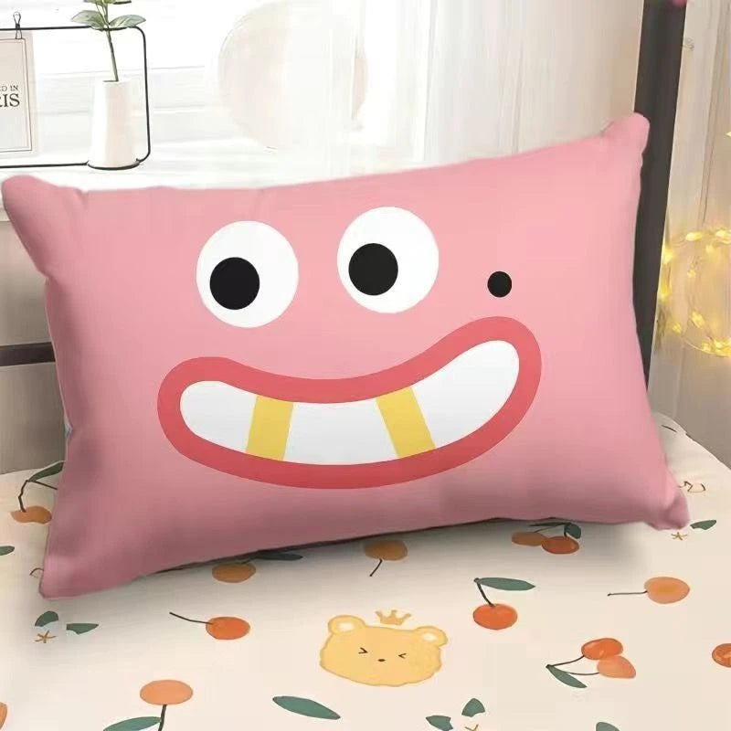Pink pillow with a cartoon face on a bed with a floral pattern