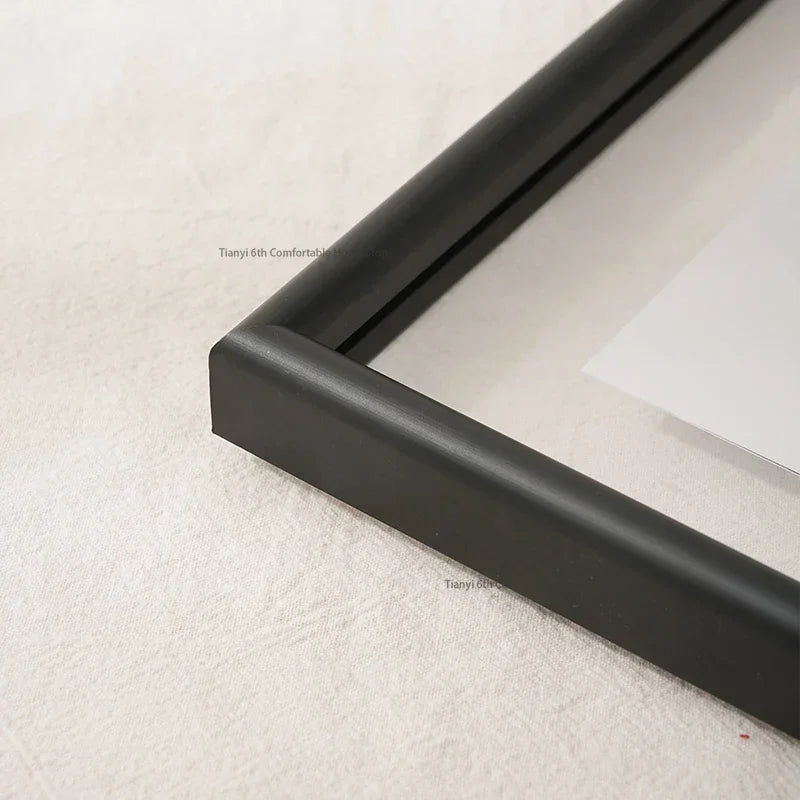 Close-up of a black picture frame corner on a white background