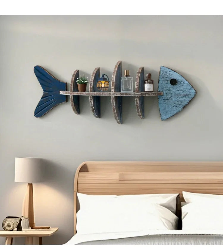Fish-shaped wall shelf with decorative items in a bedroom setting