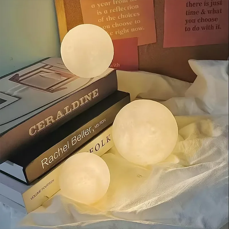 Three glowing spherical lights on a surface with books in the background