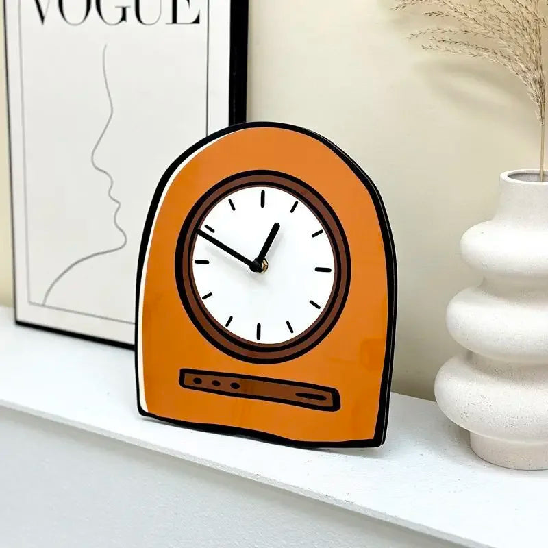 Orange clock on a shelf with a magazine and vase in the background