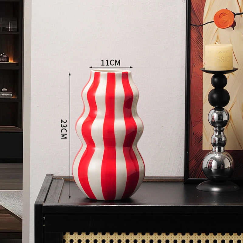 Red and white striped vase on a table with measurements indicated